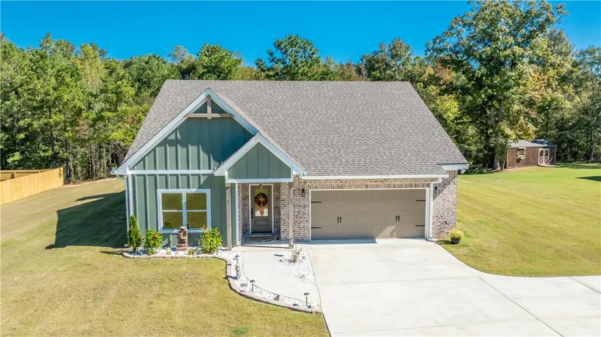 Board and batten siding pairs with brick accents on this craftsman-inspired exterior.