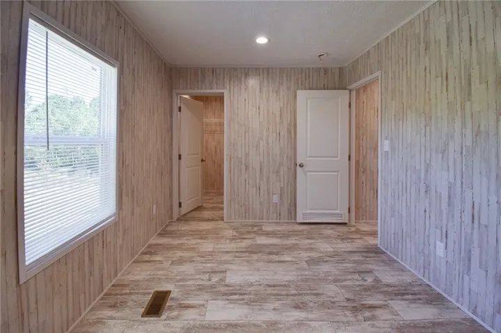 Textured wall paneling and durable vinyl plank flooring flow seamlessly throughout this functional space.