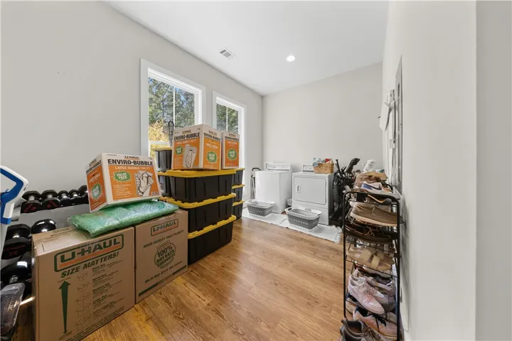 Rich wood floors and recessed lighting anchor this functional multi-use space.