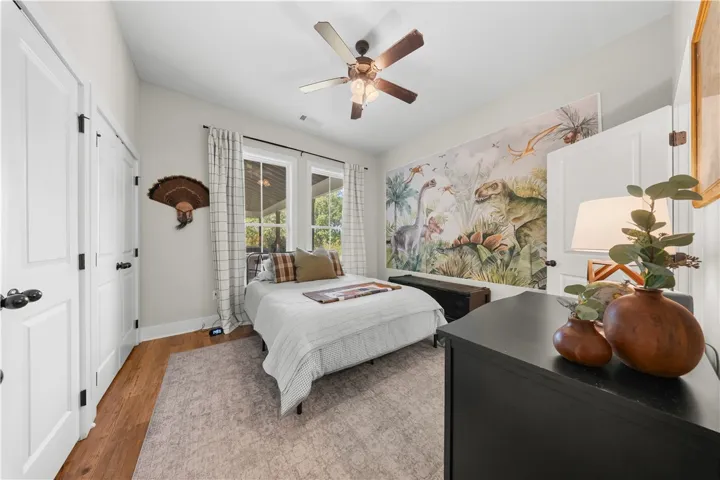 Gleaming hardwood floors and classic crown molding anchor this inviting bedroom space.