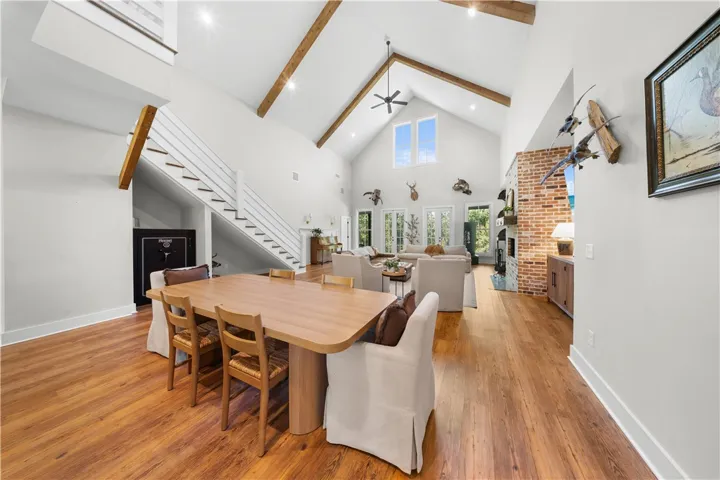 Rich wood floors and soaring beamed ceilings define this open, light-filled gathering space.