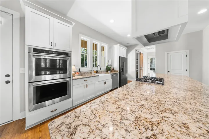 Polished granite countertops anchor this kitchen equipped with premium built-in appliances and custom cabinetry.
