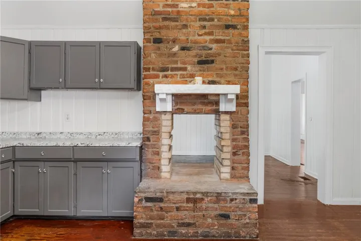 An eye-catching double-sided brick fireplace anchors this updated space with classic charm.