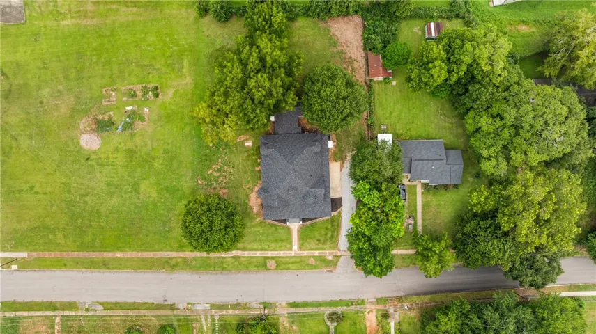 A spacious green lawn surrounds this home, shown in a straight-down aerial perspective.