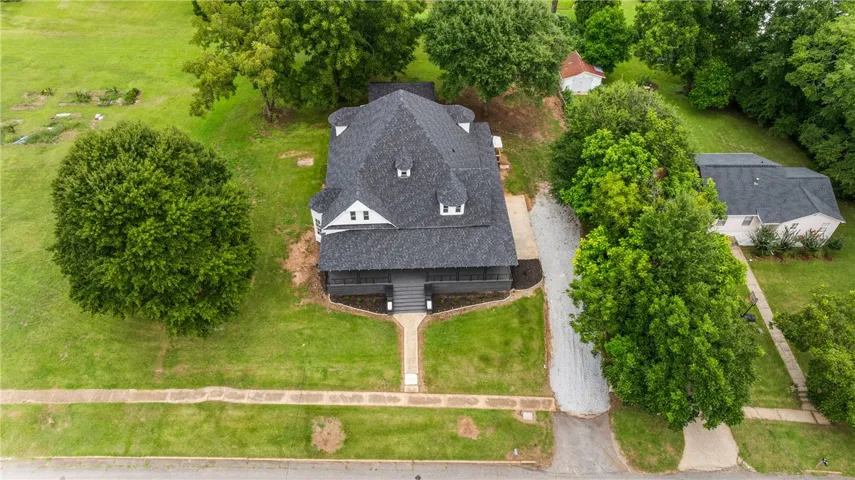 An aerial perspective showcases the classic multi-gabled roofline and expansive green grounds.