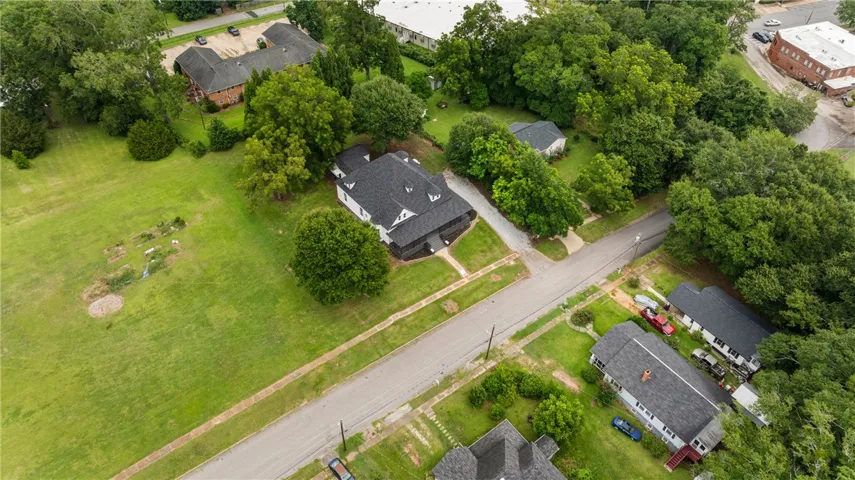 Mature trees frame the property, providing privacy and a classic neighborhood setting.