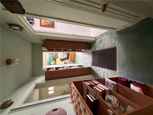A spacious central hallway features soft carpeting, built-in shelving, and classic wood trim detailing.