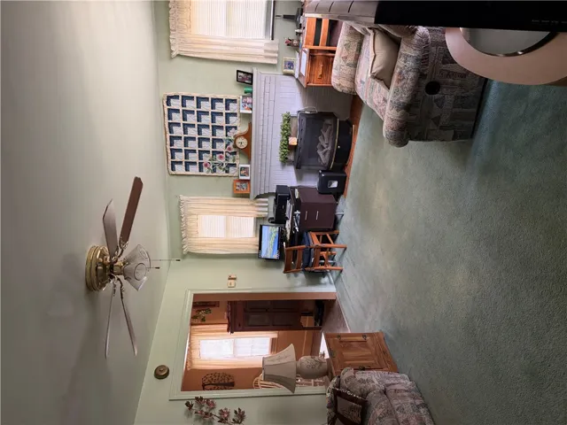 An inviting hearth centers the warm living space, framed by wide doorways and soft carpeting.