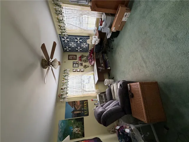 Double windows frame this versatile space featuring soft wall-to-wall carpeting and neutral walls.