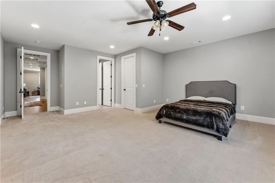 Plush carpeting and recessed lighting create a comfortable, quiet atmosphere in this secondary suite.