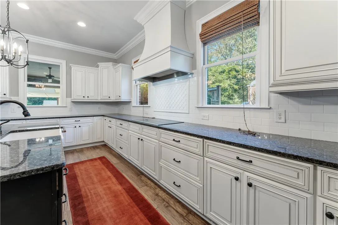 Polished granite countertops and classic cabinetry elevate this timeless kitchen space.