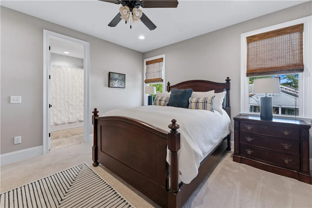 An inviting bedroom layout connects seamlessly to an adjacent bathroom vanity area.