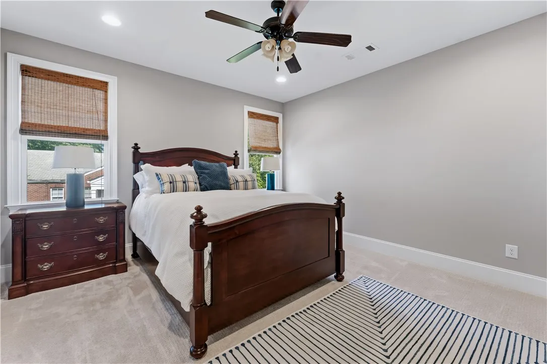 Soft carpet underfoot couples with classic trim work to establish a restful bedroom atmosphere.