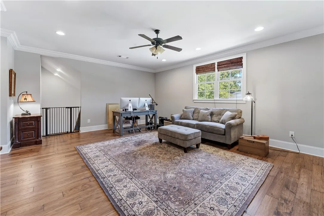 Rich hardwood flooring and crown molding define this versatile upper-level living space.