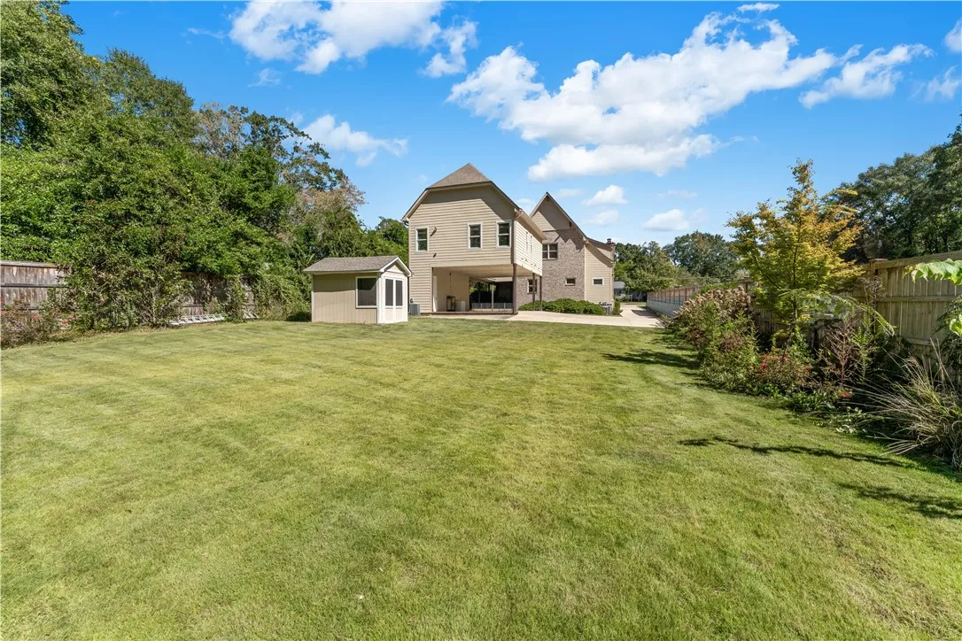 An expansive level lawn extends toward the rear exterior of this multi-level suburban home.