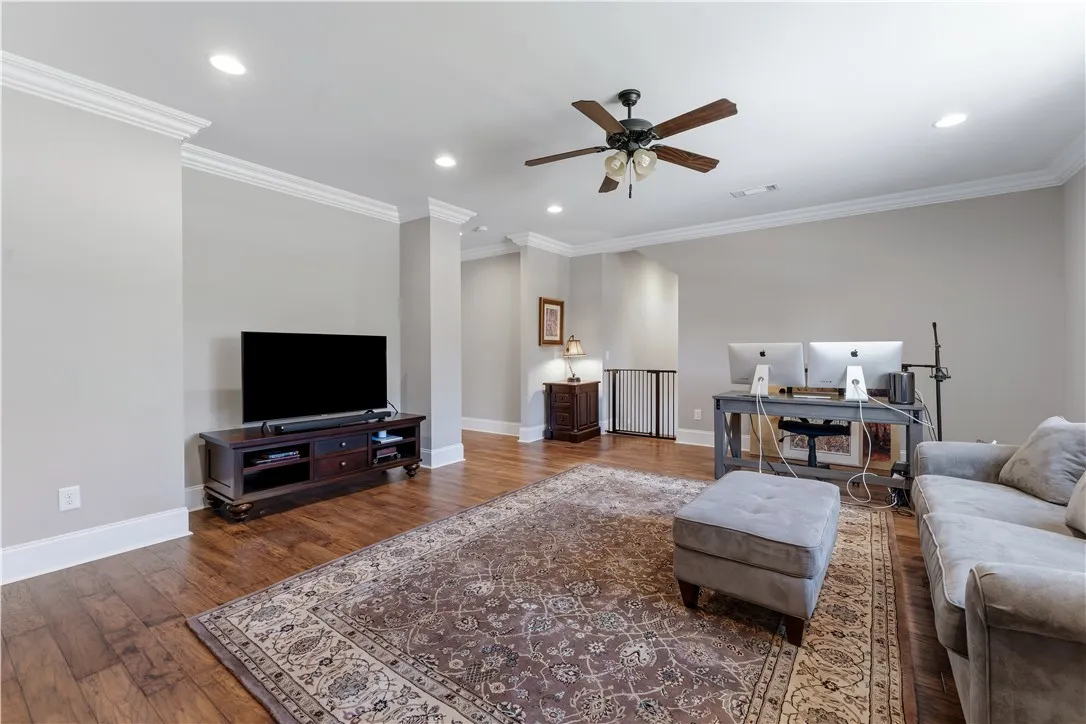 Gleaming hardwood floors and classic crown molding accent this versatile upper-level living space.