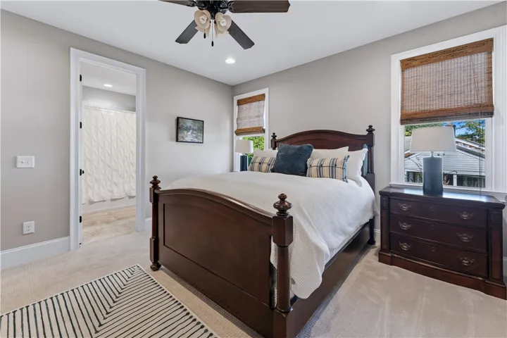 An inviting bedroom layout connects seamlessly to an adjacent bathroom vanity area.