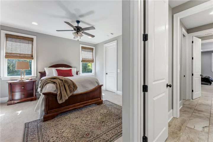 Gleaming hardwood floors and tall windows define this peaceful sleeping space.