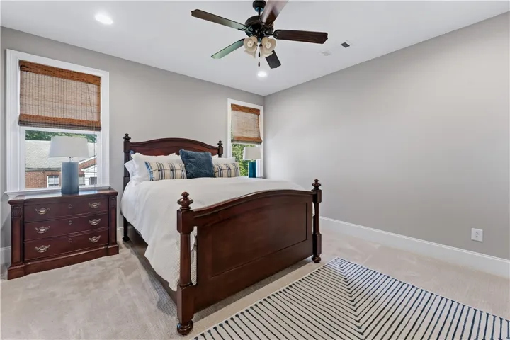Soft carpet underfoot couples with classic trim work to establish a restful bedroom atmosphere.