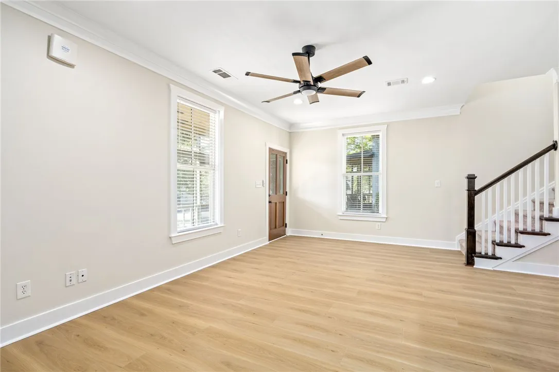 Smooth LVP floors and crisp crown molding highlight this welcoming living space.