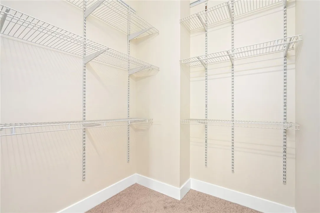 Adjustable wire shelving maximizes storage potential in this carpeted closet.