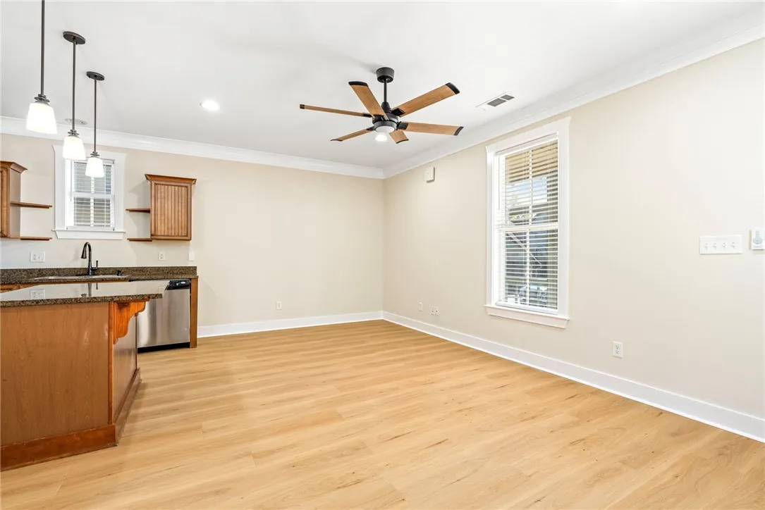 New LVP floors and detailed crown molding enhance this open-concept living area.