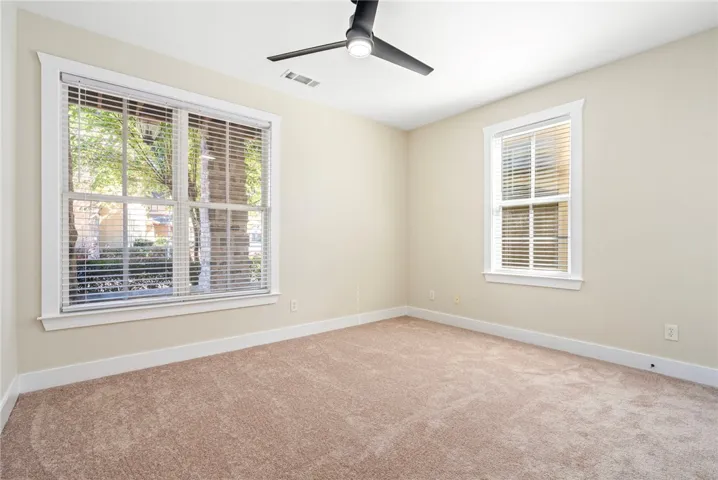 Brand new carpeting and dual windows illuminate this versatile secondary bedroom space.