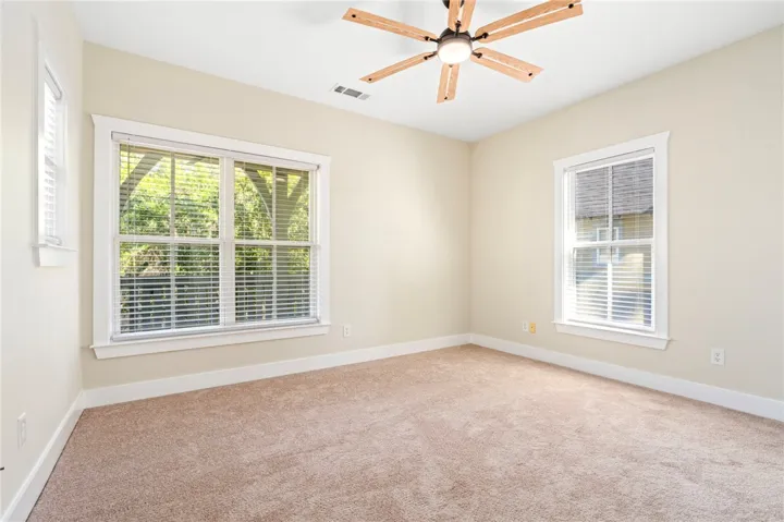 Multi-pane windows and soft carpeting create a peaceful and inviting interior space.