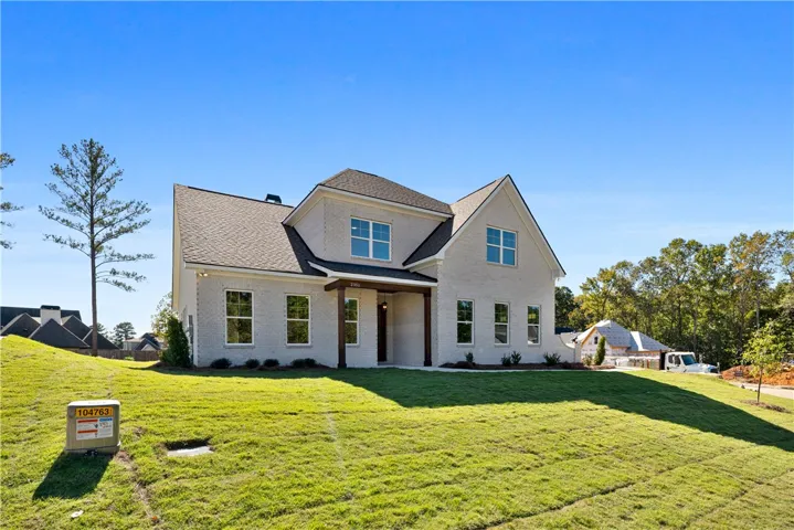 A classic brick exterior and covered entryway create immense curb appeal for this two-story home.