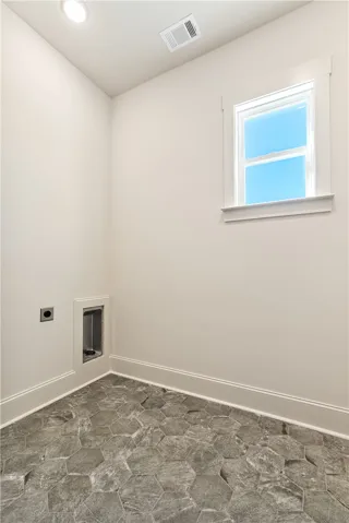 Textured hexagonal stone floor tile provides durable character under natural window light.