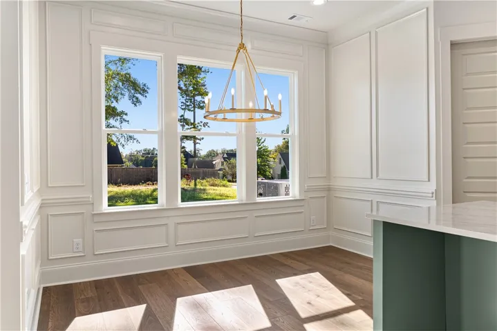Fine wainscoting and warm wood floors frame views of the scenic surrounding neighborhood.