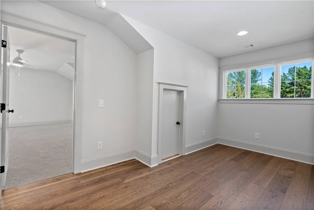Gleaming hardwood floors and clean modern trim define this versatile upstairs bonus space.