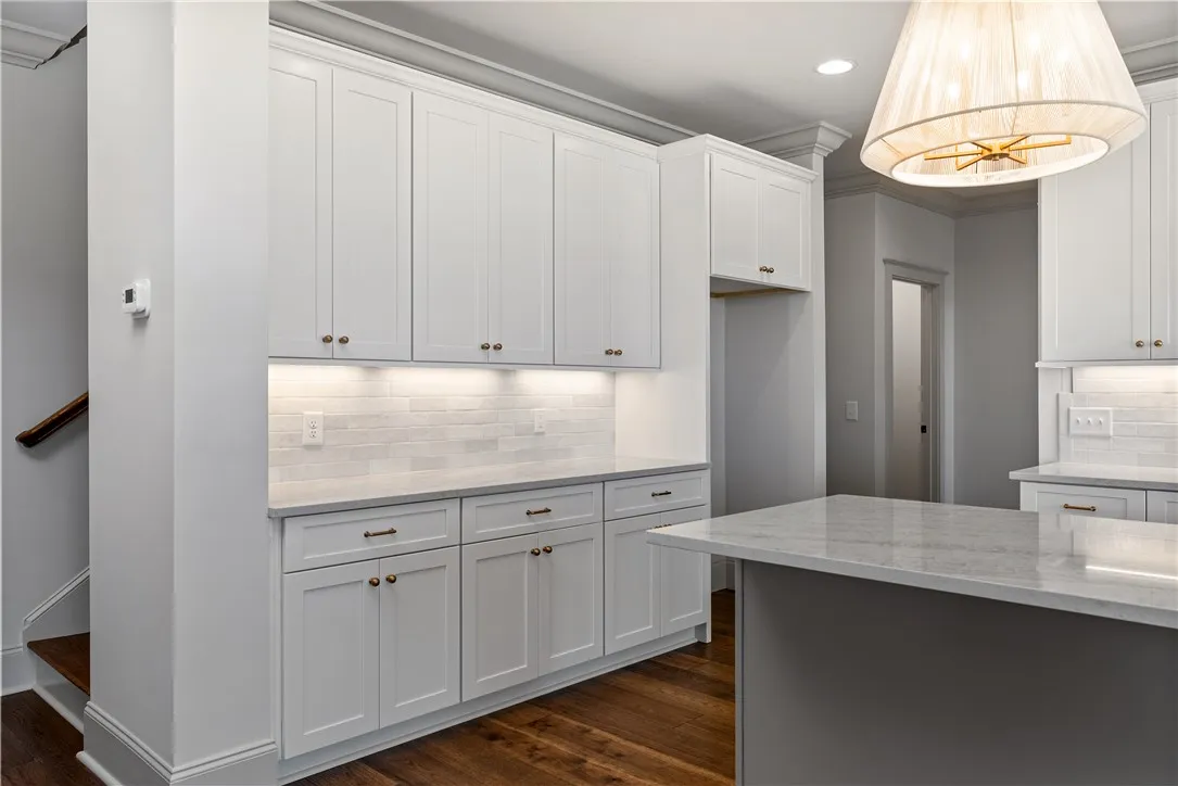 Gleaming stone countertops and classic cabinetry elevate this refined cooking space.
