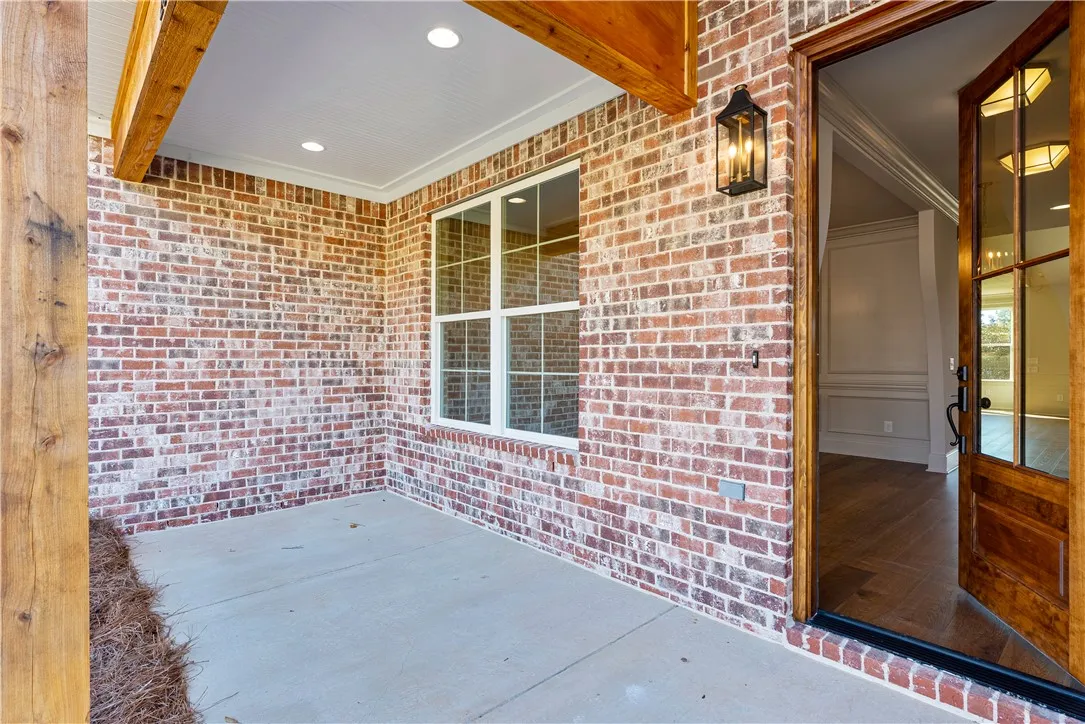 An inviting brick entryway with a concrete floor welcomes guests into the home.