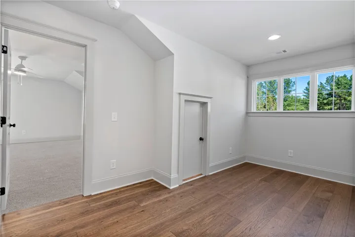 Gleaming hardwood floors and clean modern trim define this versatile upstairs bonus space.