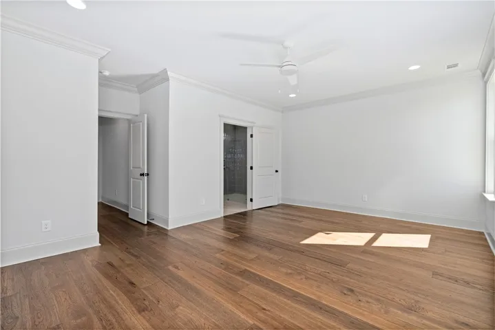 Rich hardwood flooring and classic crown molding define this clean-lined bedroom suite.