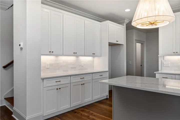 Gleaming stone countertops and classic cabinetry elevate this refined cooking space.