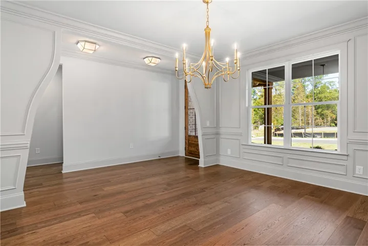 Gleaming hardwood floors and classic wainscoting highlight this elegant dining room.