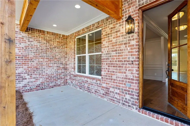 An inviting brick entryway with a concrete floor welcomes guests into the home.