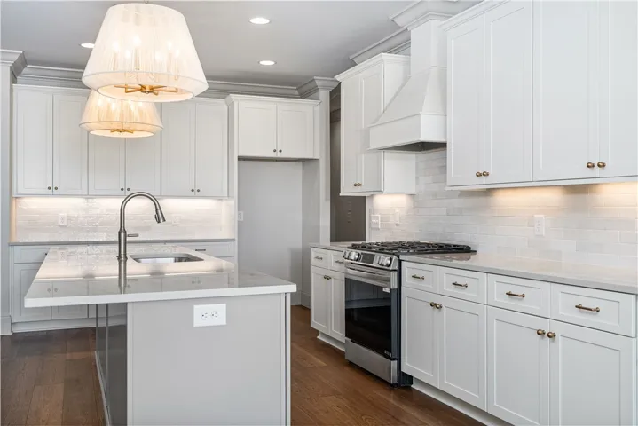 Polished hardwood flooring runs underfoot throughout this updated culinary space.