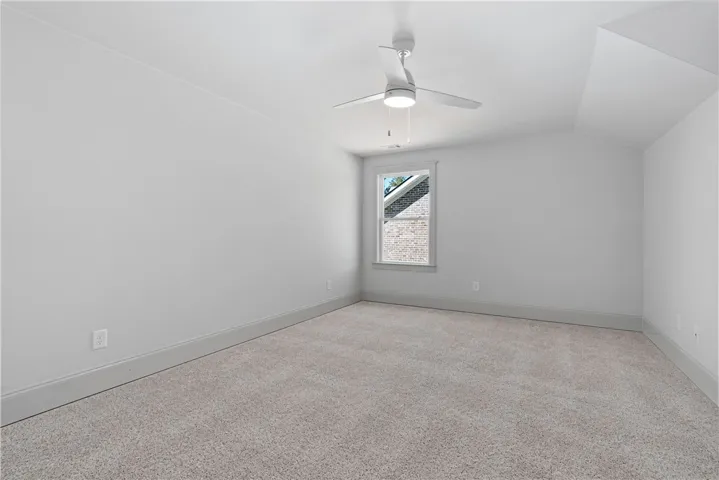 Crisp walls and plush carpeting define this versatile upper-level space.