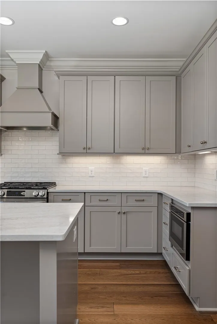 Classic crown molding and hardwood flooring frame a beautifully designed culinary workspace.
