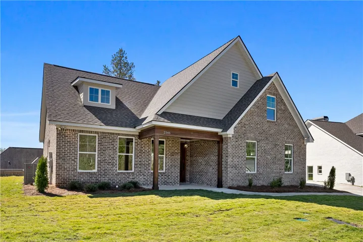 A striking brick exterior and deep gables define this contemporary multi-level residence.