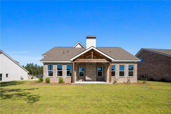 An inviting covered patio highlights the classic brick exterior of this elegant residence.