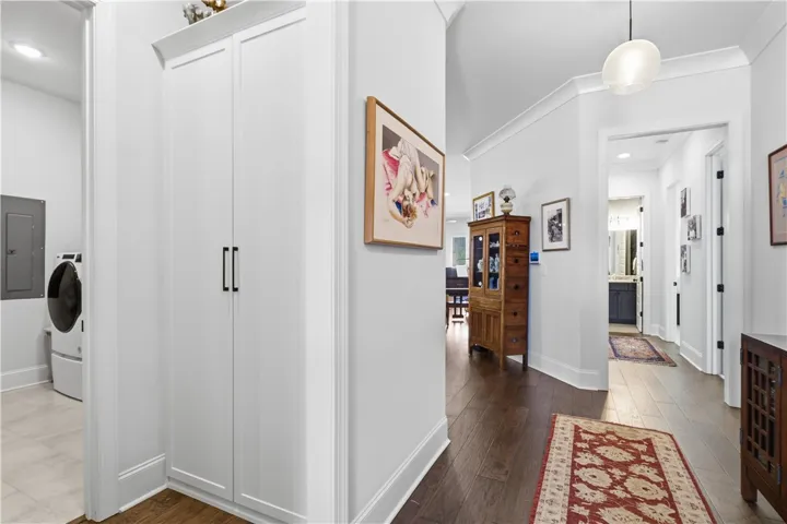Custom cabinetry at the owner’s entry establishes a functional drop zone, with the expansive laundry and conditioned flex room positioned just beyond.