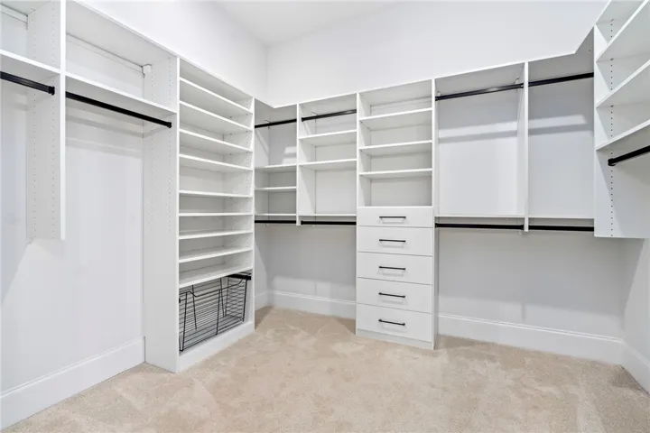 The spacious primary closet provides customized organization and generous display space.