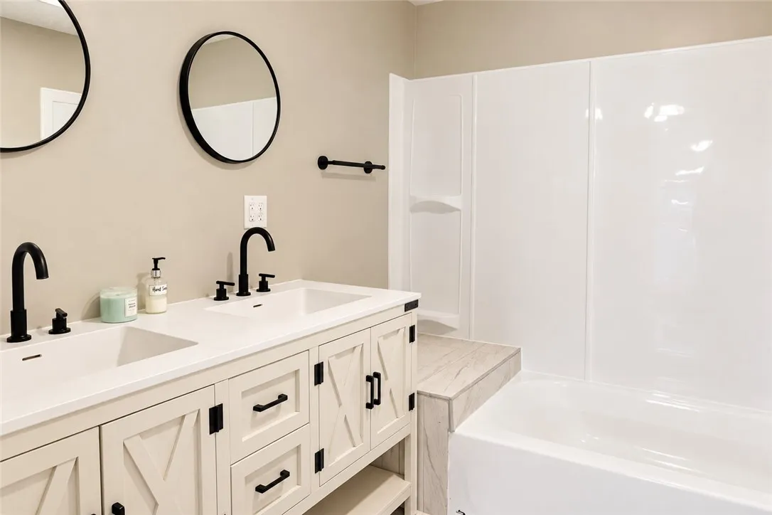 Clean lines and a spacious dual vanity define this updated secondary bath.