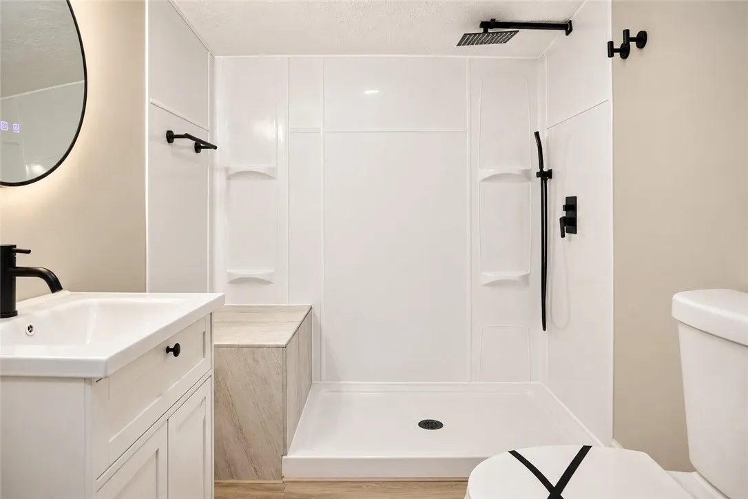 Modern fixtures and clean lines define this updated bathroom space with a walk-in shower.