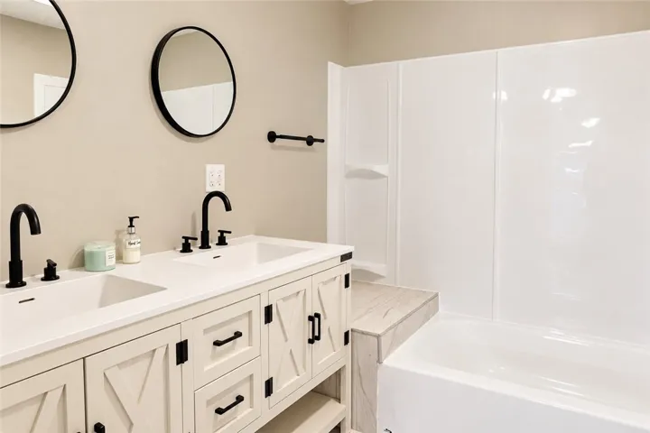 Clean lines and a spacious dual vanity define this updated secondary bath.