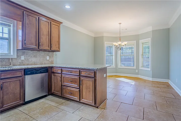 Gleaming tile floors and custom wood cabinetry define this inviting kitchen and breakfast area.